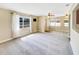 Bright and airy living room with neutral carpet, ceiling fan, and view to the dining area at 46 Morning Glory Dr, Debary, FL 32713