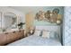 Tastefully decorated bedroom with decorative wall art, mirror, and a comfortable queen-sized bed at 4946 Foxglove Cir, Lakeland, FL 33811