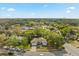 Wide aerial shot of house surrounded by mature trees and a well-established neighborhood at 520 Balsawood Ct, Altamonte Springs, FL 32714