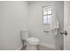 Simple half-bathroom featuring a standard toilet, window and towel rack at 520 Balsawood Ct, Altamonte Springs, FL 32714