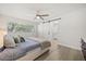 Light-filled bedroom with ceiling fan and sliding barn door leading to the ensuite bathroom at 520 Balsawood Ct, Altamonte Springs, FL 32714