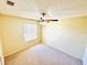 Neutral bedroom featuring plush carpeting, a ceiling fan, and a sunlit window at 527 Huxford Ct, Lake Mary, FL 32746