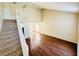 Bright living room showcasing wood floors and a staircase leading to the second floor at 527 Huxford Ct, Lake Mary, FL 32746