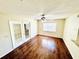 Living room with a ceiling fan, wood flooring, and glass patio doors to the backyard at 527 Huxford Ct, Lake Mary, FL 32746