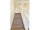 Carpeted staircase with a white railing leading to the upper level of the home at 527 Huxford Ct, Lake Mary, FL 32746