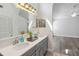 Stylish bathroom with double sinks, quartz countertops, and elegant lighting fixtures at 5600 Revelwood Loop, Winter Park, FL 32792