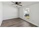 Bedroom featuring wood flooring and a window overlooking the backyard at 5600 Revelwood Loop, Winter Park, FL 32792