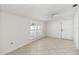 Bright bedroom with tiled flooring, plantation shutters, and a ceiling fan at 5600 Revelwood Loop, Winter Park, FL 32792