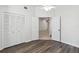 Bedroom featuring wood-look vinyl flooring and a closet with paneled doors at 5600 Revelwood Loop, Winter Park, FL 32792