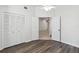 Bright and airy bedroom featuring new floors, ample closet space, and an open doorway at 5600 Revelwood Loop, Winter Park, FL 32792