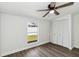 Bedroom featuring wood flooring, a ceiling fan, and a closet at 5600 Revelwood Loop, Winter Park, FL 32792