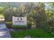 Landscaped community sign for Bridgewater, surrounded by lush greenery, welcoming residents and visitors at 5600 Revelwood Loop, Winter Park, FL 32792