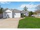 Inviting single-story home with a two-car garage and a well-maintained lawn in a suburban neighborhood at 5600 Revelwood Loop, Winter Park, FL 32792