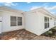 Exterior view of home with white siding, brick foundation and a wood deck at 5600 Revelwood Loop, Winter Park, FL 32792