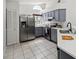 Charming kitchen boasts stainless steel appliances, sleek countertops, and ample cabinet space at 5600 Revelwood Loop, Winter Park, FL 32792
