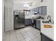 Modern kitchen featuring stainless steel appliances, gray cabinets, and a bright, airy feel at 5600 Revelwood Loop, Winter Park, FL 32792