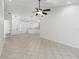 Bright, open living space featuring tiled flooring and a modern ceiling fan at 5600 Revelwood Loop, Winter Park, FL 32792