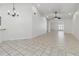 Spacious living area featuring tile floors, high ceilings, a chandelier, and plenty of natural light at 5600 Revelwood Loop, Winter Park, FL 32792