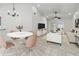 Open-concept living and dining area features neutral tones, stylish furniture, and tile flooring throughout at 5600 Revelwood Loop, Winter Park, FL 32792