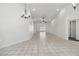 Spacious living area with vaulted ceiling, tile floors, and abundant natural light at 5600 Revelwood Loop, Winter Park, FL 32792