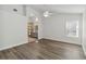 Bedroom with wood flooring and arched entry leading to the primary bathroom at 5600 Revelwood Loop, Winter Park, FL 32792