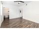 Bedroom with wood-look floors, walk-in closet, and en suite bathroom at 6412 Queens Borough Ave # 215, Orlando, FL 32835