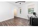 Bright bedroom with ceiling fan, wood-look floors, and natural light from two windows at 6412 Queens Borough Ave # 215, Orlando, FL 32835