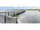 Scenic view of a wooden dock extending over the lake, offering a tranquil setting at 6412 Queens Borough Ave # 215, Orlando, FL 32835