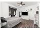 Main bedroom with wood-look floors, bay window, and modern decor at 6412 Queens Borough Ave # 215, Orlando, FL 32835