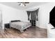 Main bedroom with wood-look floors, bay window, and minimalist modern decor at 6412 Queens Borough Ave # 215, Orlando, FL 32835