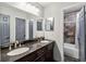 Bathroom featuring double sinks, granite countertops, and stylish tile details at 7417 Wynnewood Sq # 174, Winter Park, FL 32792