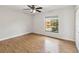 Bright bedroom featuring wood floors, a ceiling fan, and a window offering natural light at 7417 Wynnewood Sq # 174, Winter Park, FL 32792