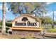 The 'Hidden Oaks' community sign features a decorative design with stone base and prominent lettering at 7417 Wynnewood Sq # 174, Winter Park, FL 32792