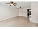 Bright, tiled living room featuring ceiling fans and easy access to the kitchen at 7417 Wynnewood Sq # 174, Winter Park, FL 32792