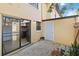 Enclosed patio with tan exterior and sliding glass door at 7417 Wynnewood Sq # 174, Winter Park, FL 32792