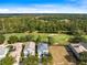 Aerial shot of a home with lush greenery and a golf course nearby, highlighting the peaceful surroundings at 7419 Gathering Ct, Reunion, FL 34747