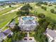 Spectacular aerial view of a community pool, golf course, and lush landscaping at 7419 Gathering Ct, Reunion, FL 34747