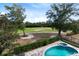 Aerial view of a backyard with pool, hot tub, and golf course views at 7419 Gathering Ct, Reunion, FL 34747