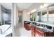 Luxurious bathroom featuring dual vanities, soaking tub, and bright natural light at 7419 Gathering Ct, Reunion, FL 34747