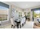 Bright dining area with a modern table and chairs, bathed in natural light from the surrounding windows at 7419 Gathering Ct, Reunion, FL 34747