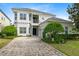 Charming two-story home with manicured landscaping and a paved driveway, offering classic curb appeal and a welcoming entry at 7419 Gathering Ct, Reunion, FL 34747