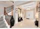 Inviting foyer area with wood and iron staircase, tile flooring and a double door entry at 7419 Gathering Ct, Reunion, FL 34747