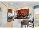 Bright kitchen with stainless steel refrigerator, custom cabinetry, breakfast bar, and tile flooring at 7419 Gathering Ct, Reunion, FL 34747