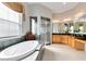 Bright bathroom featuring soaking tub, large shower, dual vanities and granite countertop at 7419 Gathering Ct, Reunion, FL 34747