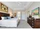 Spacious main bedroom featuring tray ceiling, furniture, artwork, and ensuite bathroom at 7419 Gathering Ct, Reunion, FL 34747