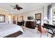 Serene main bedroom showcasing a king-sized bed, dresser, desk, and a tranquil atmosphere at 7419 Gathering Ct, Reunion, FL 34747