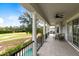 Expansive outdoor patio with comfortable seating overlooks a lush golf course and sparkling pool at 7419 Gathering Ct, Reunion, FL 34747