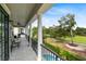 Covered outdoor patio offers stunning views of the golf course and community pool for relaxation and entertainment at 7419 Gathering Ct, Reunion, FL 34747