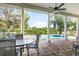 Covered patio with ample seating, ceiling fan, and a view of the pool and landscaped backyard at 7419 Gathering Ct, Reunion, FL 34747