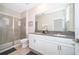 Contemporary bathroom with dual sinks, shower, and elegant white cabinetry at 830 Sticks, Davenport, FL 33896